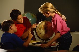 students looking at globe