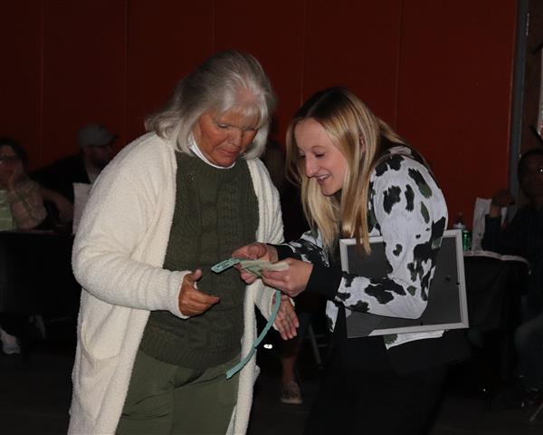 Alumna Nina Komosinski checks the 50/50 winner's ticket