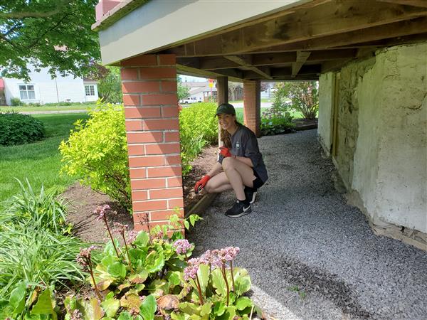 Student working from under the porch
