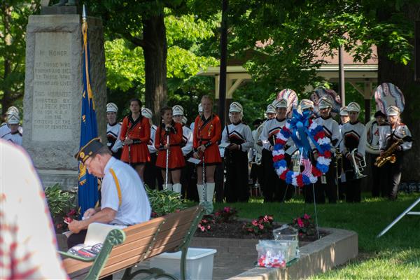 Marching band behind park memorials