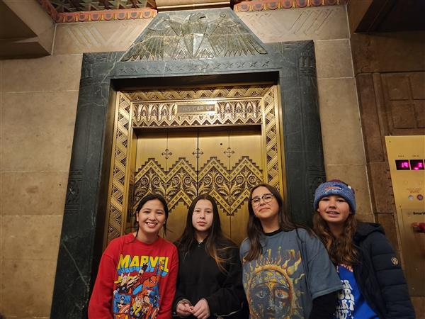 Students pose in front of elevator - look at the details!