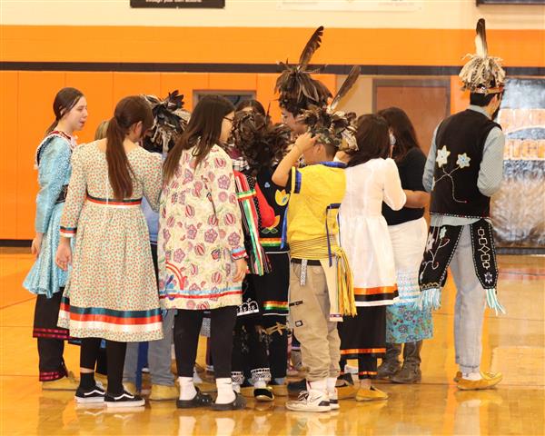 Dancers huddle together before next dance