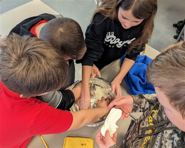 Students mixing cloud dough