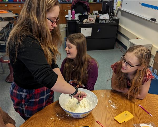 Students mixing cloud dough