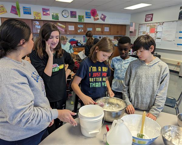Students mixing cloud dough