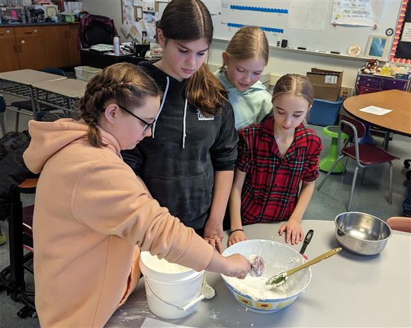 Students mixing cloud dough