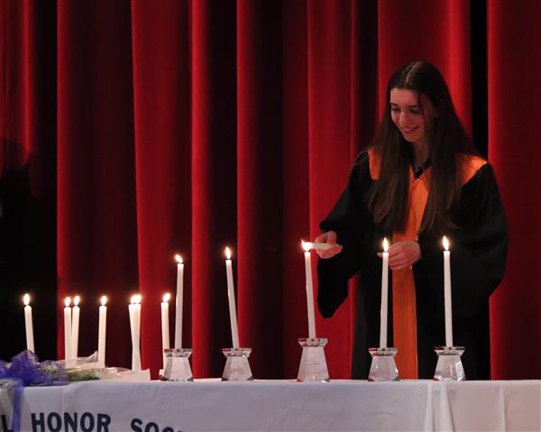 Rebecca Higgins lighting candle