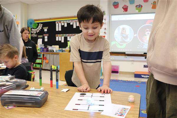 Kindergartner with robot