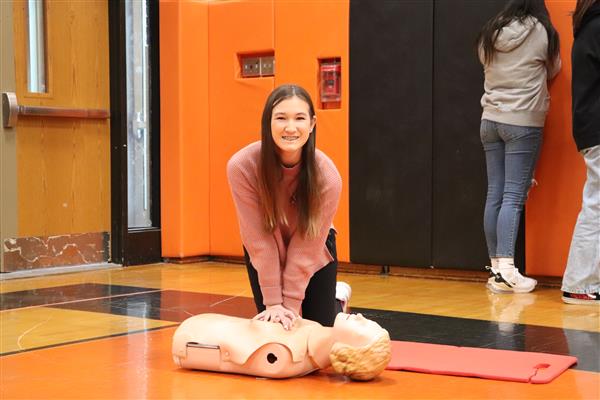 Student smiling while practicing CPR
