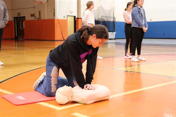 Hailey practicing Hands Only CPR