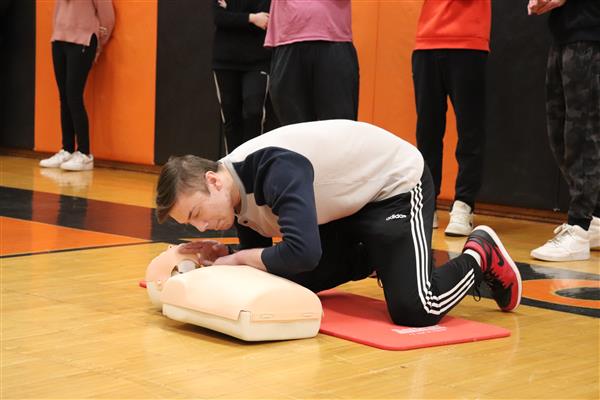 Student checking for breathing