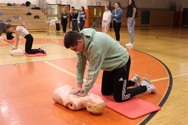 Student practicing Hands Only CPR