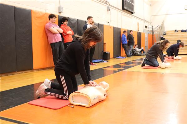 Alexis practicing Hands Only CPR