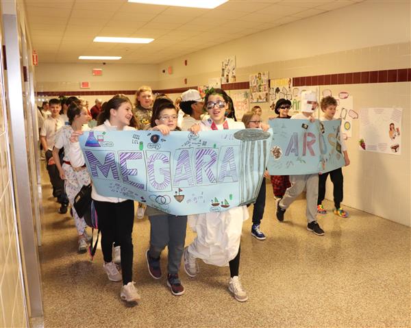 Students parade the hallway with banners