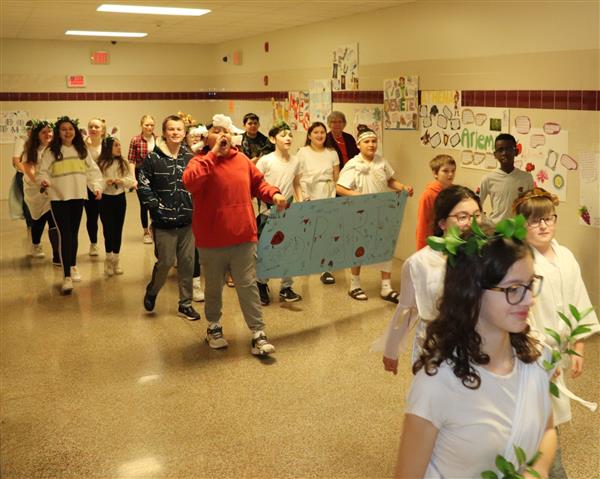 Students parade the hallway with banners