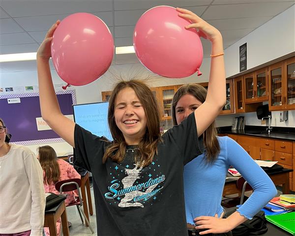 Student's hair sticking to balloons