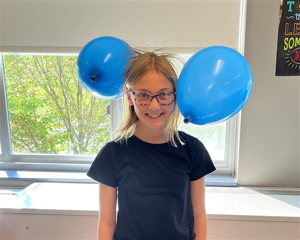 Balloons sticking to a student's head