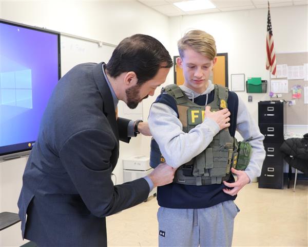 Cole getting fitted with utility vest