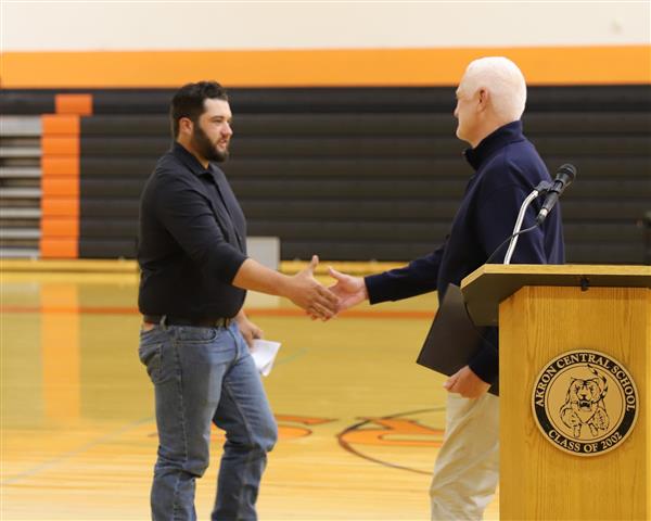 Coach Bell shakes hands with Tommy James