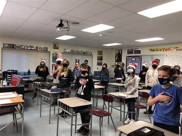 Students stand for the pledge in holiday apparel
