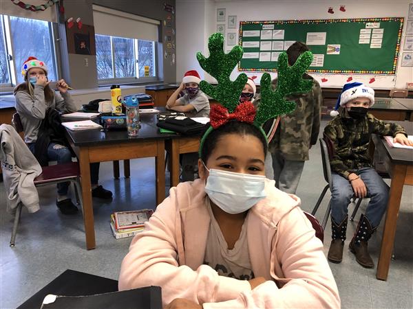 Student with holiday headgear